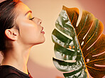 Beauty, makeup and profile of woman with leaf for luxury cosmetics, skincare products and fashion. Neon studio, creative art deco and face of girl with plant for self care, glamour and satisfaction
