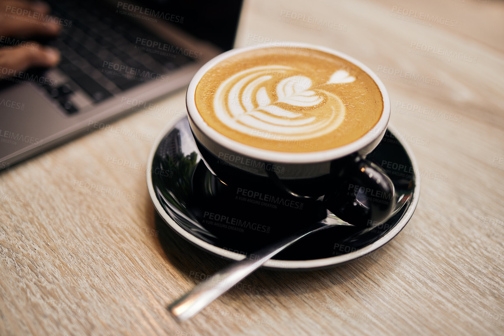 Buy stock photo Closeup, coffee or cappuccino with art in cafe, restaurant or bistro for drinking. Hot beverage, latte or flat white on table , spoon and order for customer with sweet, delicious and aroma for taste