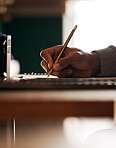 Hand of student, pencil and notes for study, research and university education at desk. College, exam class and person with notebook, ideas and information for learning, knowledge and writing test.