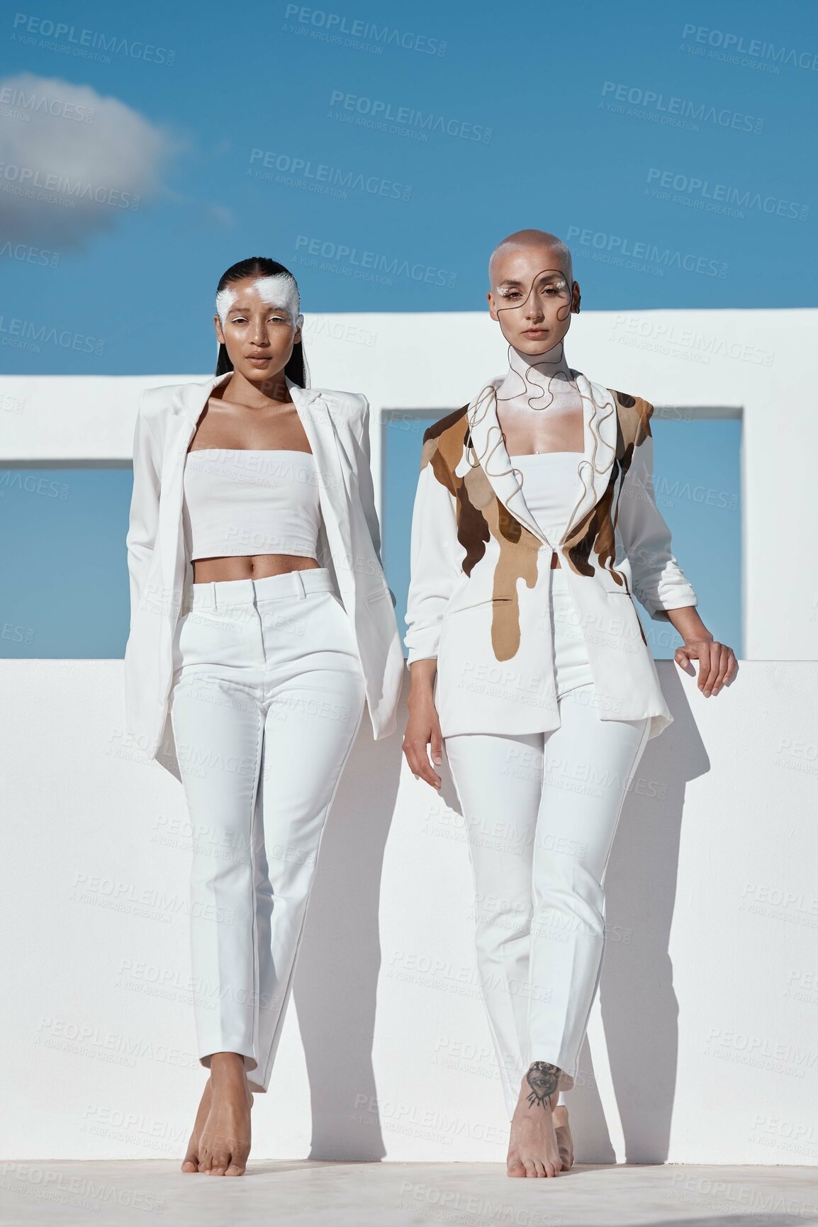 Buy stock photo Shot of two beautiful young women wearing creative make-up and stylish white clothes