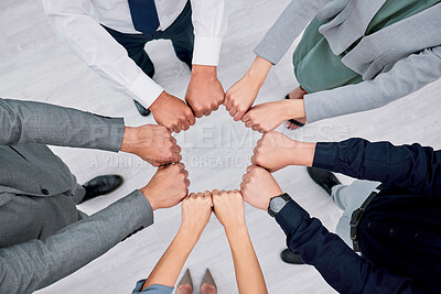 Buy stock photo Hands, fist circle and business people solidarity, unity and together in support, team building or colleague trust. Top view floor, group meeting and community cooperation, synergy or goal commitment