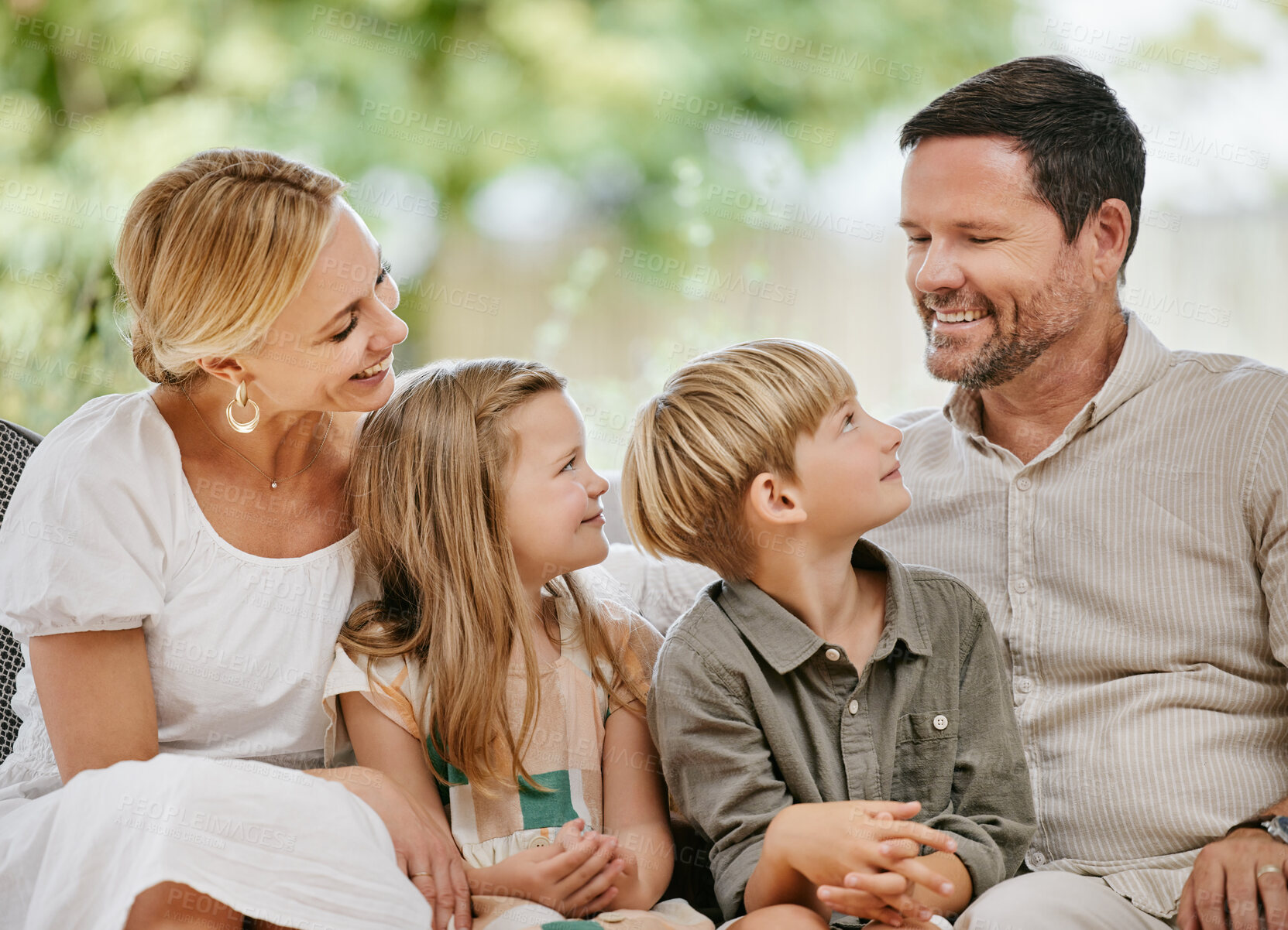 Buy stock photo Smile, happy and kids with parents on a sofa relaxing in the living room of modern house. Bonding, love and young children together, resting and sitting with mother and father in the lounge at home.