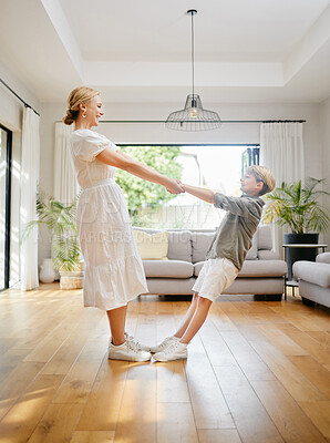 Buy stock photo Mom, dance and holding hands with child in home, living room or lounge with trust, support or balance. Mother, love and care for kid in house and moving to music, song or listening to radio together