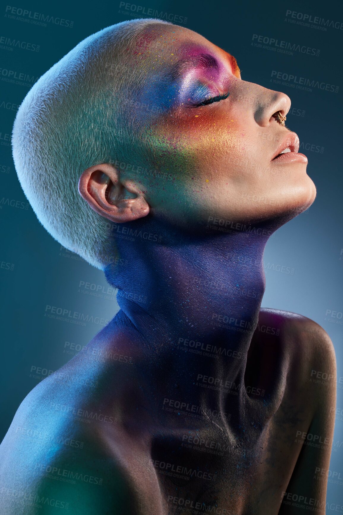 Buy stock photo Studio shot of a young woman posing with multi-coloured paint on her face