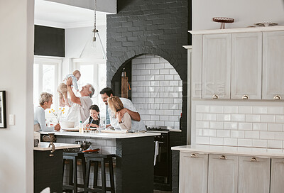 Buy stock photo Baking, happy and big family bonding in kitchen for food with conversation in a house. Cooking, communication and children with parents and grandparents for breakfast, lunch or dinner in family home