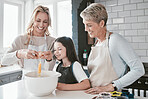 Mom, grandmother and kid baking together in kitchen, family home and house of fun, learning or development. Happy family generation, girl and child crack eggs for dessert, cookies and teaching recipe