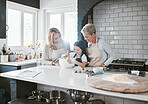 Happy, joyful and loving mother and grandmother cooking, baking and preparing food with their daughter and grandchild. Happy, cheerful and carefree girl learning to bake with her family in kitchen