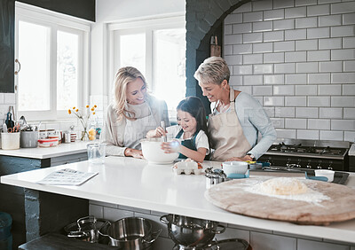 Buy stock photo Happy, joyful and loving mother and grandmother cooking, baking and preparing food with their daughter and grandchild. Happy, cheerful and carefree girl learning to bake with her family in kitchen