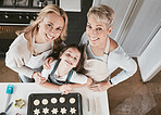 Baking, above and girl with mother and grandmother in the kitchen for cookies in their house. Cooking, bonding and portrait of a child with mom and senior woman learning to bake in their family home