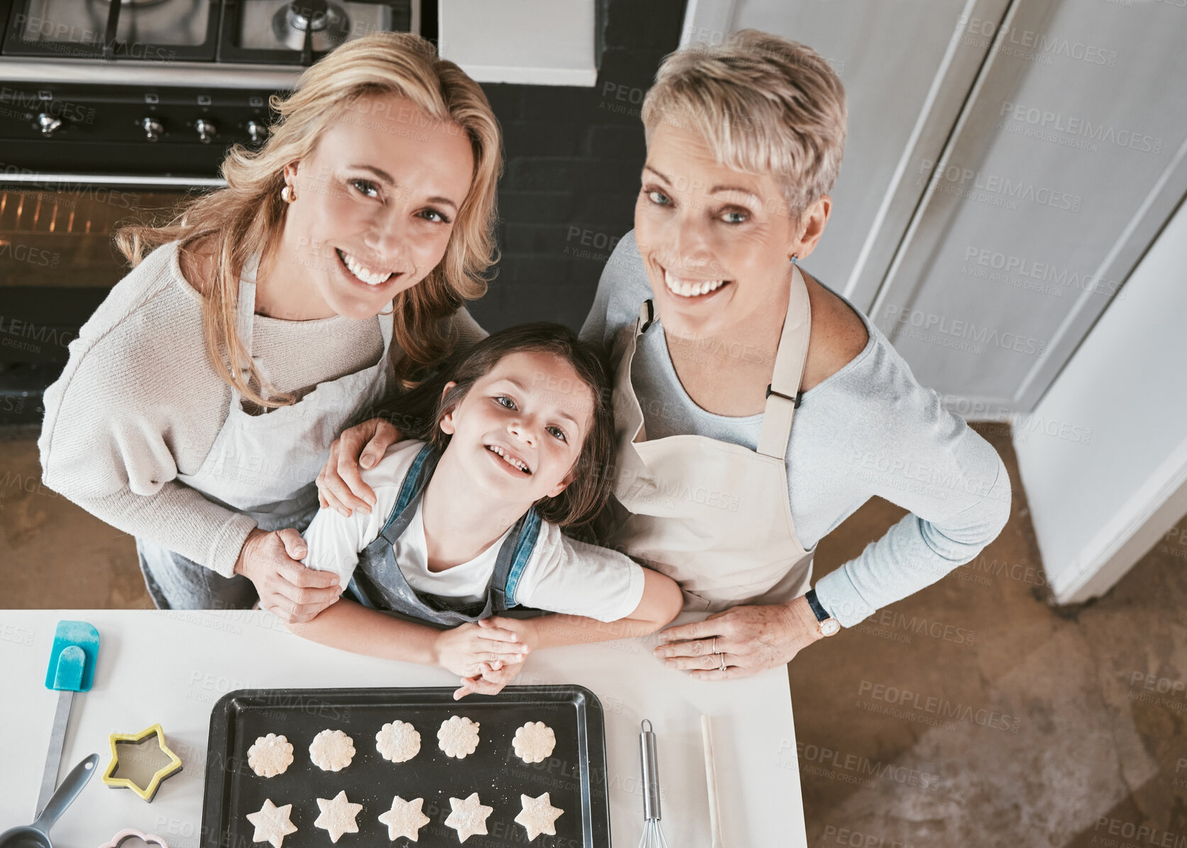 Buy stock photo Baking, above and girl with mother and grandmother in the kitchen for cookies in their house. Cooking, bonding and portrait of a child with mom and senior woman learning to bake in their family home