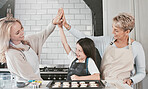 Baking, high five and child with mother and grandmother for success, support and teamwork in the kitchen. Goal, motivation and girl kid with mom and senior woman for cookies in the family home