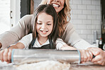 Happy, kitchen and mother baking with her child for a celebration, event or dinner at their home. Happiness, rolling pin and mom cooking supper or lunch with her girl kid while bonding at their house