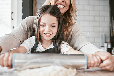 Buy stock photo Happy, kitchen and mother baking with her child for a celebration, event or dinner at their home. Happiness, rolling pin and mom cooking supper or lunch with her girl kid while bonding at their house