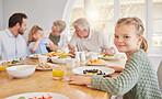 Girl child, portrait and breakfast with family, smile and morning in home with diet, nutrition or eating. Kid, plate and happy for fruit, juice and relax in home dining room, parents and grandparents