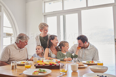 Buy stock photo Parents, kids and grandparents at breakfast, happy and eating together on holiday, bonding and food in family home. Men, women and girl children with fruits, waffles and diet choice in dining room