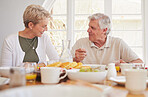 Breakfast, talking and portrait with senior couple, mother and happy together in a home. Love, support and care on a dining room with a smile and food with bonding in the morning with fruit in