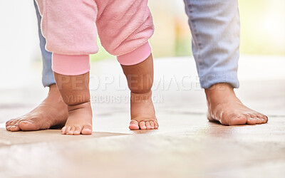 Buy stock photo Walking, learning and feet of parent and baby on floor for child development, growth and first steps at home. Family, childhood and closeup of toddler for bonding, relationship and balance in nursery
