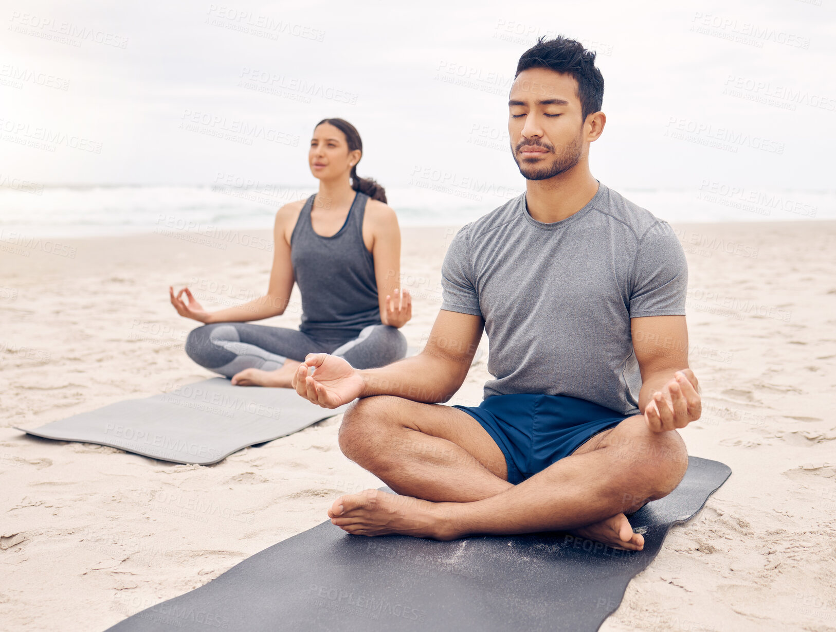 Buy stock photo Couple of friends, lotus pose and beach meditation for zen fitness, calm exercise and mindfulness or holistic wellness. Young people in meditation, yoga by sea and ocean or nature for mental health