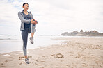 Fitness, warm up and woman athlete on the beach for health and race, marathon or competition training. Sports, workout and young female runner stretching for cardio exercise by the ocean or sea.