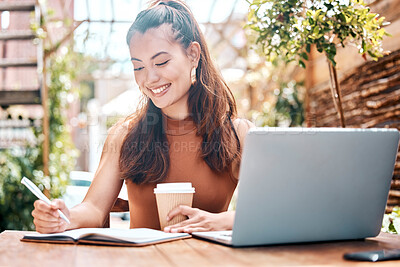 Buy stock photo Happy woman, coffee and writing in notebook at cafe smile for planning with laptop for research. Creative, remote work and excited emoji for online article, social media post or project for future