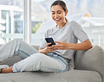 Woman, phone and happy for texting on sofa, reading and web blog with notification in home living room. Girl, smartphone and happy with typing, story or post on app for social media on couch in house