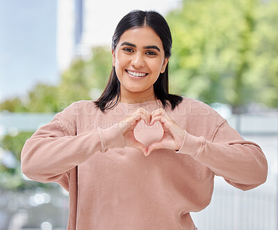 Buy stock photo Happy woman, heart and hand with smile in portrait, outside or street for self care, wellness or peace. Mexican person, student and gesture for hope in community support, change or social justice