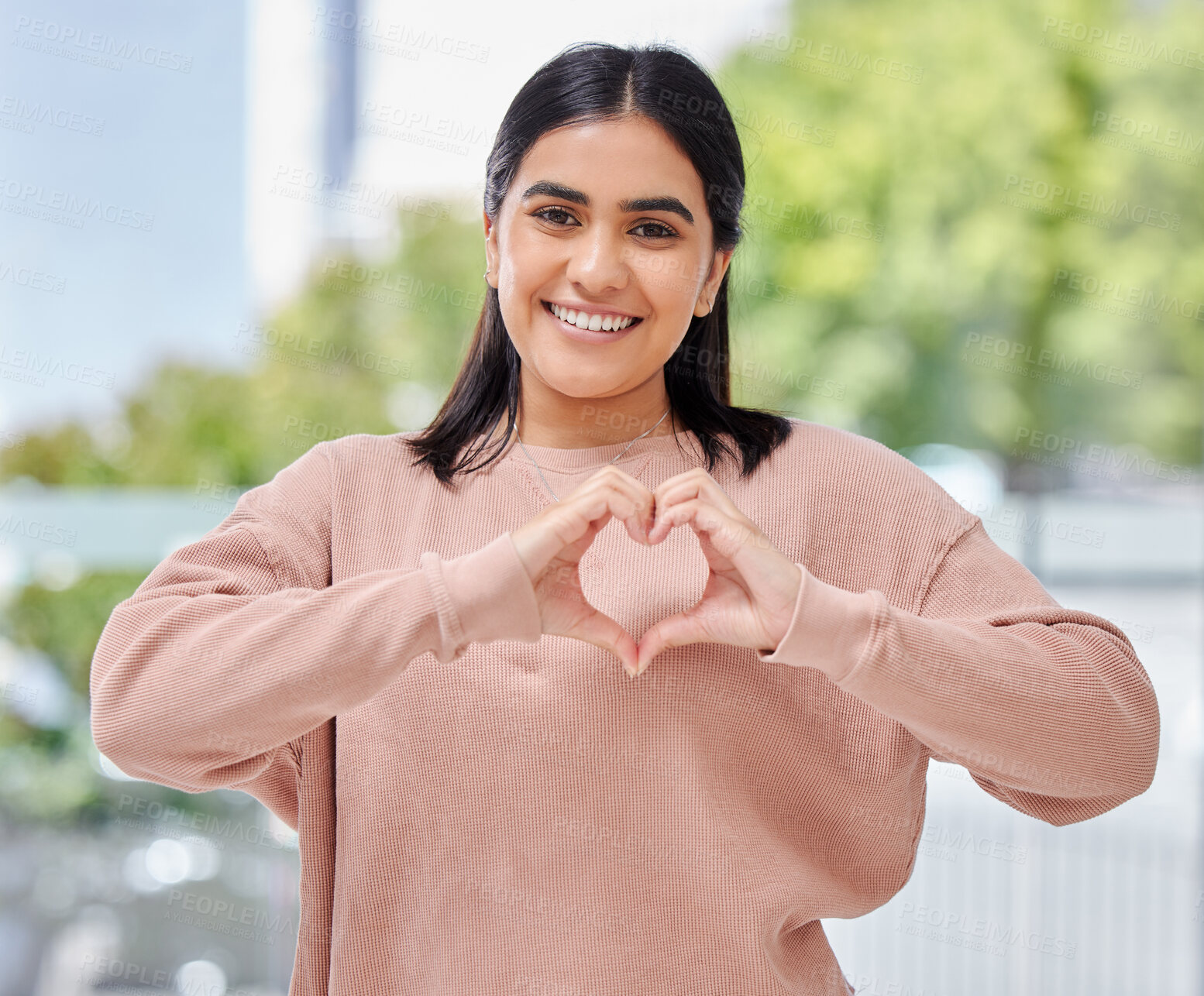 Buy stock photo Happy woman, heart and hand with smile in portrait, outside or street for self care, wellness or peace. Mexican person, student and gesture for hope in community support, change or social justice