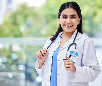Young woman, doctor and hospital portrait with smile, stethoscope and healthcare career with pride. Female latino medic, happy health and wellness expert with medical job, clinic and help in services