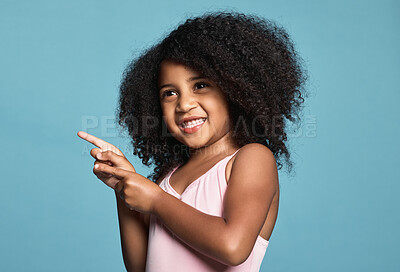 Buy stock photo Advertising, hand and child with smile, happy and finger for blue mockup studio background. Face of a young African girl in happiness while pointing to show attention to marketing and mock up space