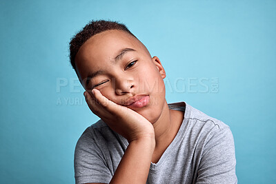 Buy stock photo Tired child face on blue background, depression while lazy thinking and rest on hand in studio. Sad black boy with adhd, bored kid with depressed insomnia and mental health fatigue in young children