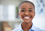 Portrait, smile and a confident business black woman closeup in an office with a mindset of ambition. Face, trust and teeth with a happy young employee looking satisfied in her professional workplace