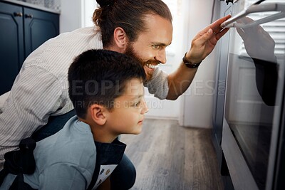 Buy stock photo Father and son baking cake together in kitchen at home, bonding and waiting by oven stove. Loving, adoptive single parent taking care of curious little boy learning to bake or cook.