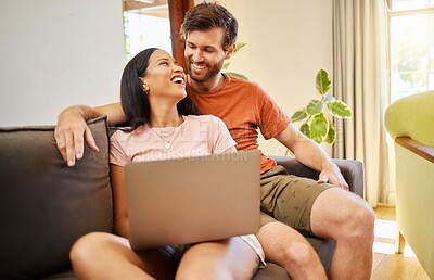 Buy stock photo Couple talking and browsing on a laptop while relaxing on a sofa at home. Girlfriend and boyfriend scrolling on social media or the internet with technology while having conversation in living room.