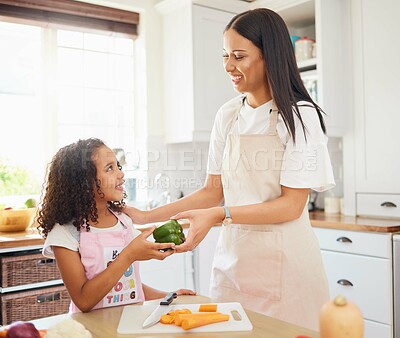 Buy stock photo Food, learning and cooking by mother and daughter in a kitchen, teaching health and independence. Family, vegetables and child development with happy, excited girl prepare healthy meal with parent