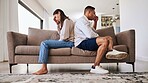 Fight, frustrated and couple with a problem in their marriage on the living room sofa of their house. Sad, angry and depressed man and woman thinking of divorce, conflict and mistake on the couch