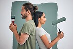 Paint, renovate and diy with a couple in their home for painting, redecorating or improvement. House, interior and room with a man and woman painting a wall in their apartment for renovation