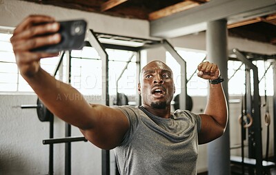 Buy stock photo Gym selfie, smartphone and man flexing arm muscle for a post gyming pump bodybuilding exercise for online social media. Black man, fitness workout trainer and bodybuilder training for wellness health
