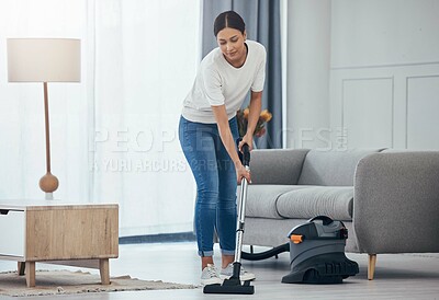 Buy stock photo Woman, vacuum machine and cleaning the floor in the living room in home. Happy latino cleaner doing housework, housekeeper or job in a clean lounge, hotel room or house while alone spring cleaning