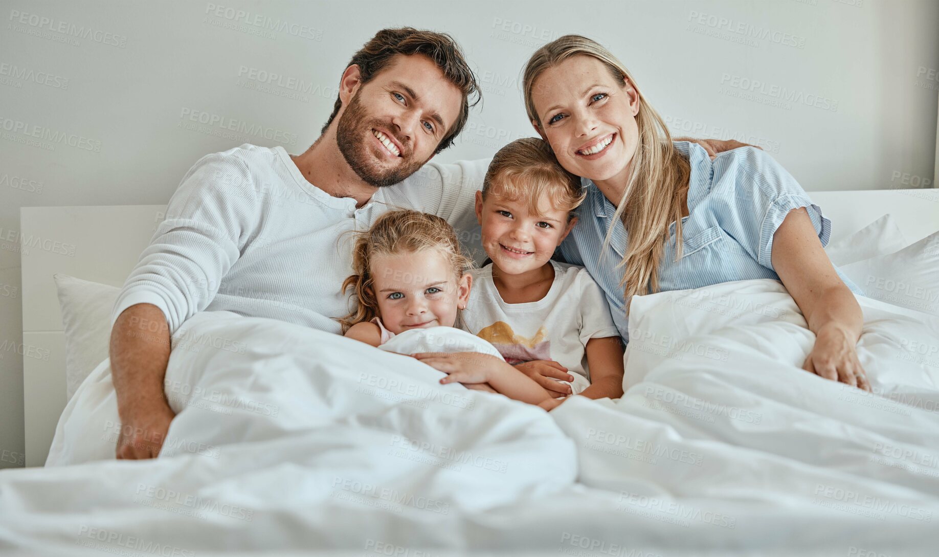 Buy stock photo Family, children and bed with a girl, sister and parents in the bedroom of a home to relax together in the morning. Portrait, love and smile with a happy mother, father and daughter siblings bonding