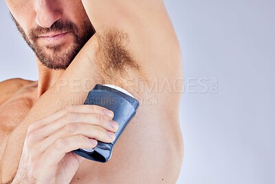 Hygiene, cleaning and man with deodorant in studio on purple background for body care. Health, wellness and male model using products for grooming, freshness and clean body with closeup of armpit