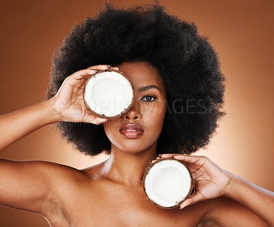 Buy stock photo Beauty, coconut and skincare, black woman with natural product for diy facial treatment, organic and fresh portrait. Hair, face and healthy skin with afro and natural cosmetics with studio background