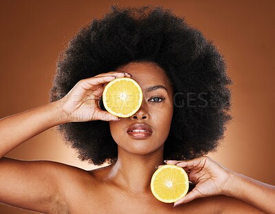 Buy stock photo Lemon, black woman and vitamin c skincare, beauty and wellness, healthy food and detox, natural cosmetics and afro hair on studio background. Portrait, african and vegan model, citrus fruit and face