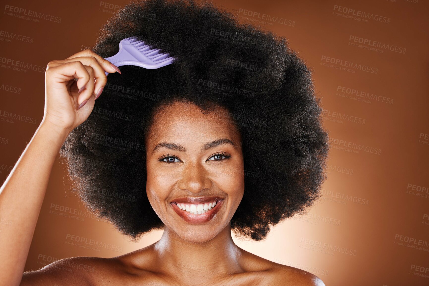 Buy stock photo Hair care, beauty and black woman with comb in afro smiling in studio on brown background. Fashion, hair salon and face portrait of girl brushing natural, curly and healthy hair with organic products