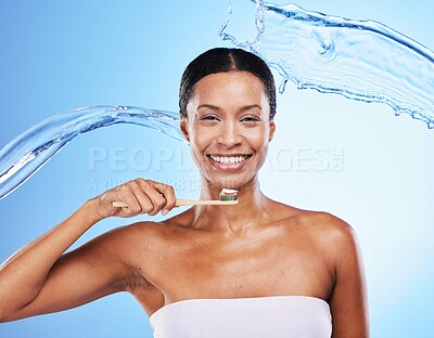 Buy stock photo Dental, water and black woman with toothbrush, clean breath and health for teeth and gums, hygiene portrait against blue studio background. Oral health, toothpaste and beauty with water splash.