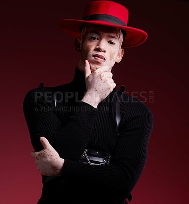 Buy stock photo Man, fashion style or vitiligo skin on red background studio in empowerment, self love or attitude. Portrait, aesthetic or model with cool, stylish or edgy clothes or South Africa facial pigmentation