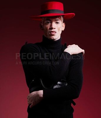 Buy stock photo Fashion, aesthetic and portrait of man on red background with style, beauty and designer cosmetics in studio. Creative, art and male model with vitiligo pose with stylish, modern and luxury clothing