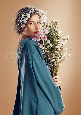Buy stock photo Aesthetic woman, beauty and flowers on studio background for cosmetics, skincare and dermatology during spring in Amish culture. Portrait of female model with flower for natural nature fashion style