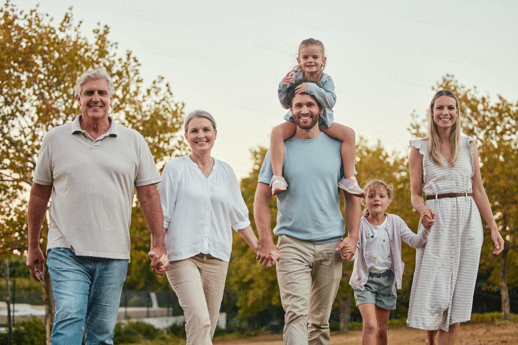 Buy stock photo Nature, portrait and big family on a walk in the park for fresh air, exercise and adventure. Grandparents, parents and children walking together and holding hands in an outdoor garden in Australia.