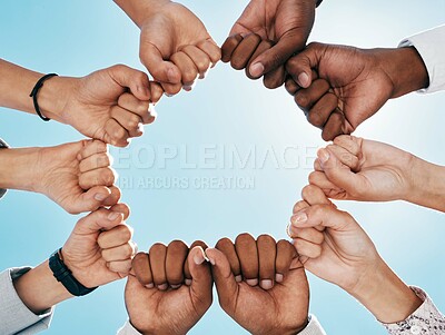 Buy stock photo Fist hands, circle and teamwork of business people for team building with low angle outdoors. Blue sky, collaboration and support, unity or union of group, men and women in huddle for goal motivation