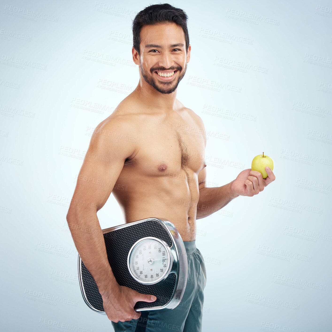 Buy stock photo Fitness, portrait or man with an apple or scale in studio for motivation to lose weight on a healthy diet. Fruit, nutrition or male model with body goals, training target or happy smile with mockup